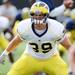 Michigan senior defensive end Will Heininger stretches during warm ups at practice on Tuesday.  Melanie Maxwell I AnnArbor.com

